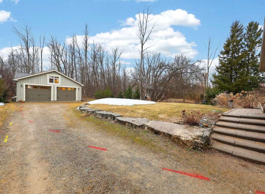 Discover this charming property featuring a detached garage and a spacious driveway, perfect for multiple vehicles.