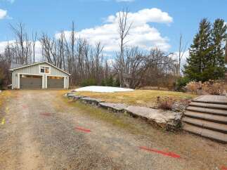 Discover this charming property featuring a detached garage and a spacious driveway, perfect for multiple vehicles.