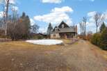 This stunning property boasts a charming exterior with a welcoming porch and a well-maintained yard.