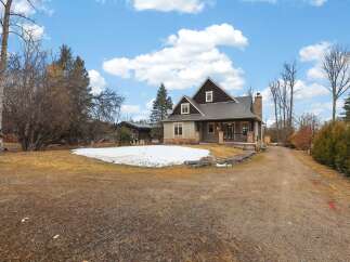 This stunning property boasts a charming exterior with a welcoming porch and a well-maintained yard.