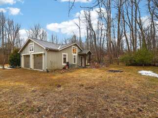 Nestled in a serene wooded setting, this charming property offers a perfect blend of comfort and nature.