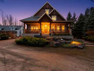 This stunning property boasts a beautiful exterior with a welcoming porch and inviting entrance.