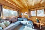 This cozy living space features a stunning wooden interior, creating a warm and inviting atmosphere.