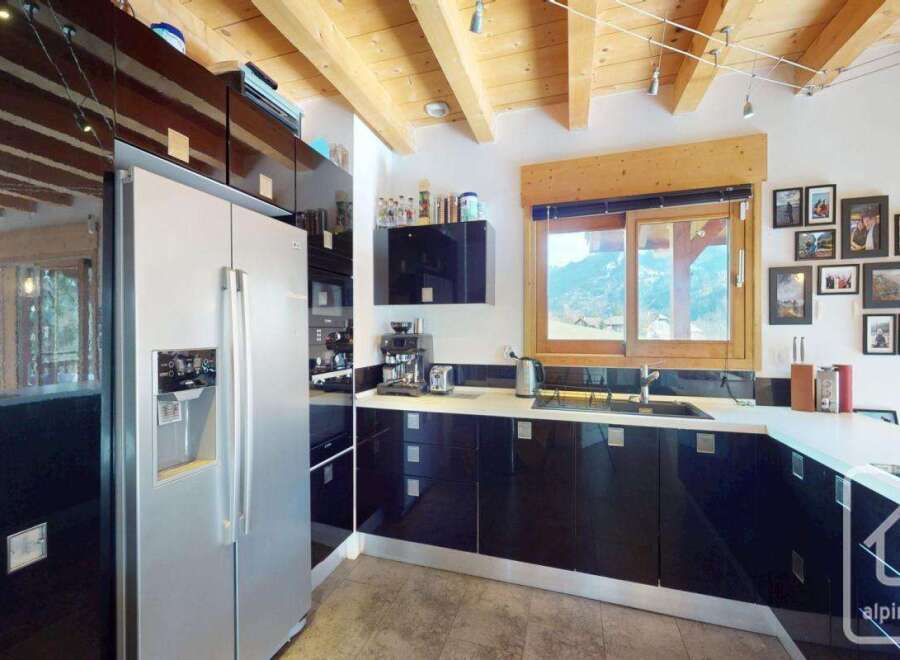 This stunning kitchen boasts modern design with sleek black cabinetry and stainless steel appliances.