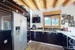This stunning kitchen boasts modern design with sleek black cabinetry and stainless steel appliances.