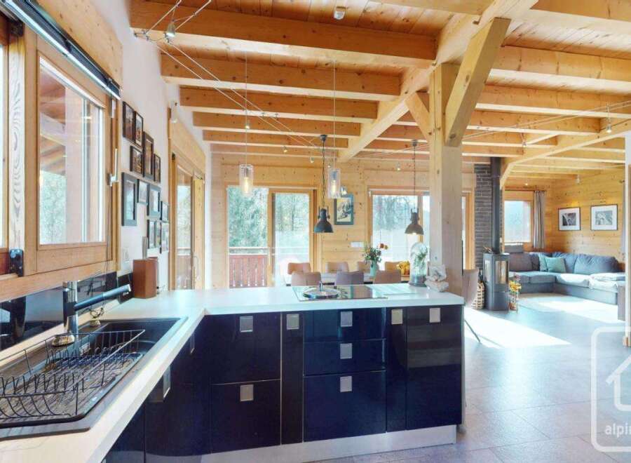 Experience the charm of this stunning property, featuring a modern kitchen with sleek black cabinetry and a spacious layout.