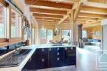 Experience the charm of this stunning property, featuring a modern kitchen with sleek black cabinetry and a spacious layout.