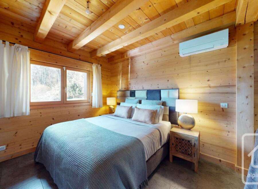 Experience the warmth of this charming bedroom, featuring stunning wooden accents throughout.