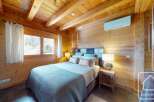 Experience the warmth of this charming bedroom, featuring stunning wooden accents throughout.