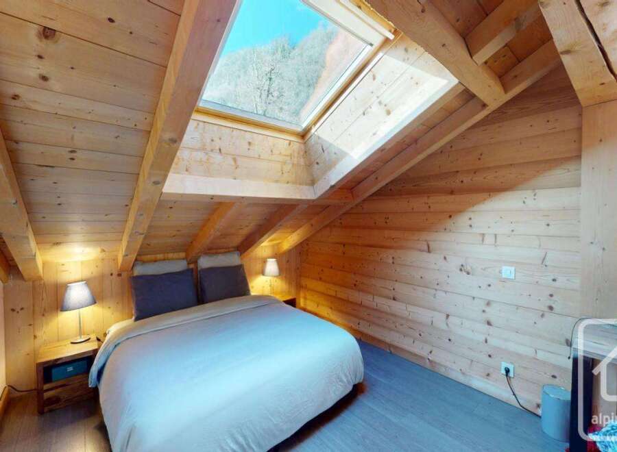 Discover the charm of this cozy bedroom, featuring a unique sloped ceiling and a skylight that floods the space with natural light.