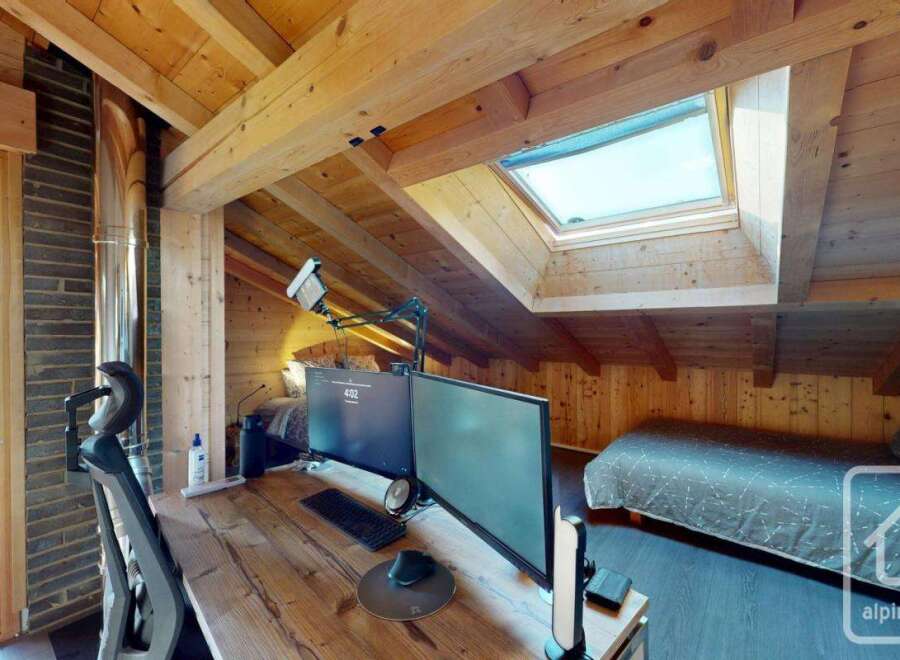 Discover the charm of this cozy attic space, perfect for a home office or a relaxing retreat.