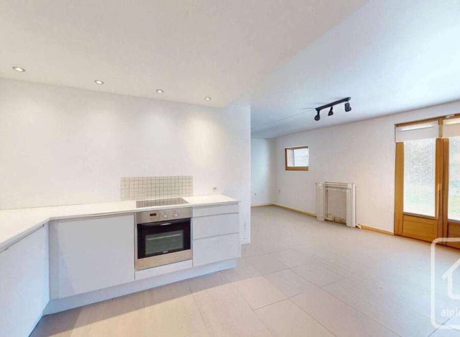 Discover this modern kitchen with sleek white cabinetry and stainless steel appliances.