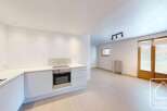 Discover this modern kitchen with sleek white cabinetry and stainless steel appliances.