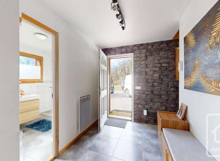 Step into this inviting entryway, showcasing a blend of modern and rustic design elements.