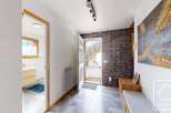 Step into this inviting entryway, showcasing a blend of modern and rustic design elements.