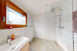 This modern bathroom features a sleek design with a walk-in shower and a stylish vanity.