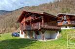 Discover the charm of this stunning wooden chalet nestled in a picturesque mountain setting.
