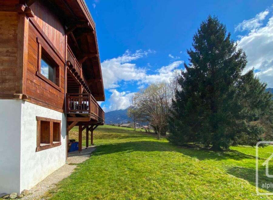 Discover the charm of this stunning property, boasting a beautiful wooden facade and a serene, grassy landscape.