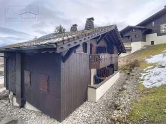 Discover a charming chalet nestled in a picturesque mountain setting.