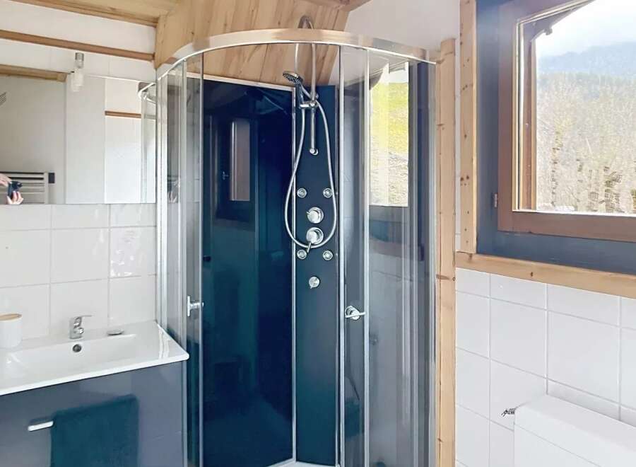 This stunning bathroom features a modern shower with multiple jets, perfect for a relaxing experience.