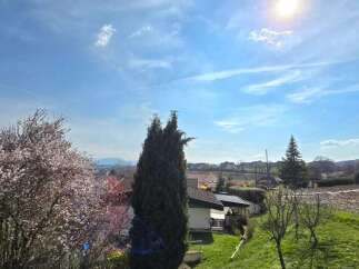 Enjoy breathtaking views from this stunning property, featuring lush greenery and a vibrant sky.