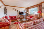 This charming living room offers a cozy and inviting atmosphere, perfect for relaxing after a day on the slopes.