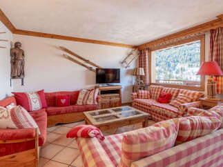 This charming living room offers a cozy and inviting atmosphere, perfect for relaxing after a day on the slopes.