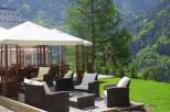 Enjoy breathtaking mountain views from this luxurious outdoor seating area.