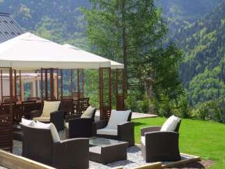 Enjoy breathtaking mountain views from this luxurious outdoor seating area.