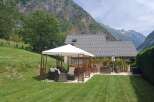 Escape to your own mountain retreat! This stunning property boasts a beautifully manicured lawn, perfect for outdoor gatherings.