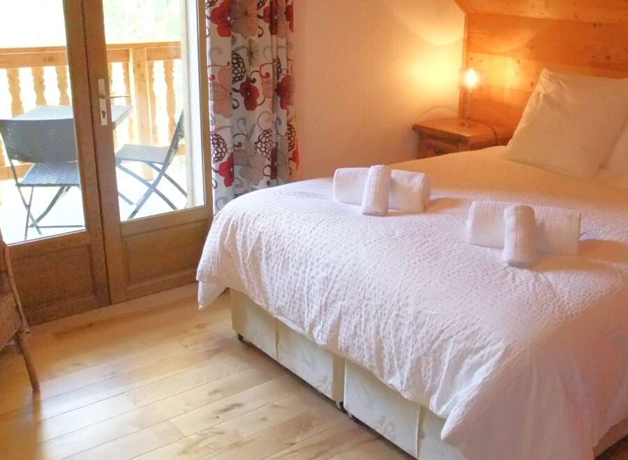 This charming bedroom offers a cozy retreat with a touch of elegance.
