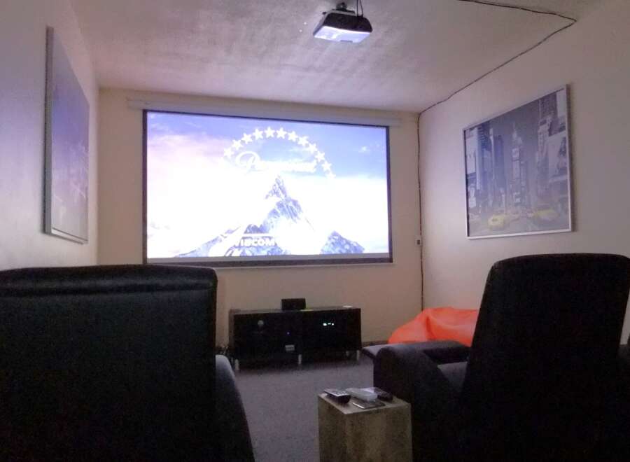 Step into your dream home theater! This space features a large projector screen, perfect for movie nights and entertaining.