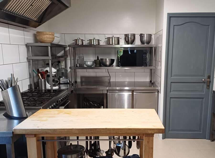 This commercial kitchen boasts a spacious layout, perfect for culinary endeavors.