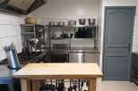 This commercial kitchen boasts a spacious layout, perfect for culinary endeavors.
