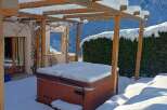 Enjoy the winter wonderland from the comfort of your own home! This property features a cozy hot tub, perfect for relaxing after a day on the slopes.