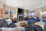 Step into luxury with this stunning living room, featuring a cozy fireplace and a large flat-screen TV, perfect for entertaining.