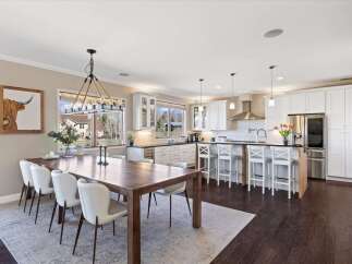 Step into luxury with this stunning kitchen and dining area.