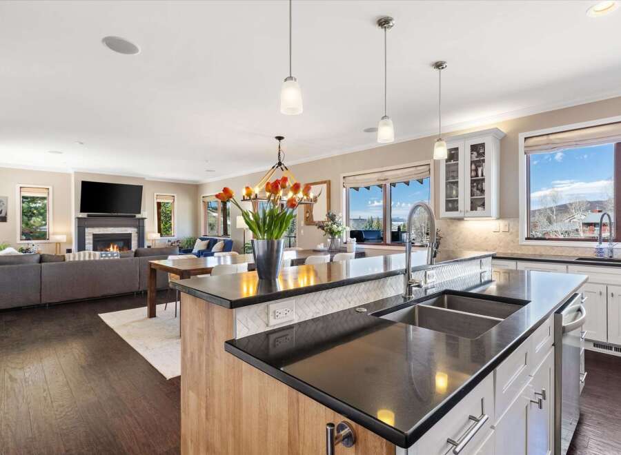 This stunning kitchen boasts a modern design with sleek countertops and a spacious island, perfect for culinary enthusiasts.