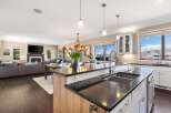 This stunning kitchen boasts a modern design with sleek countertops and a spacious island, perfect for culinary enthusiasts.