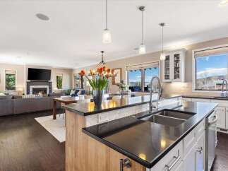 This stunning kitchen boasts a modern design with sleek countertops and a spacious island, perfect for culinary enthusiasts.