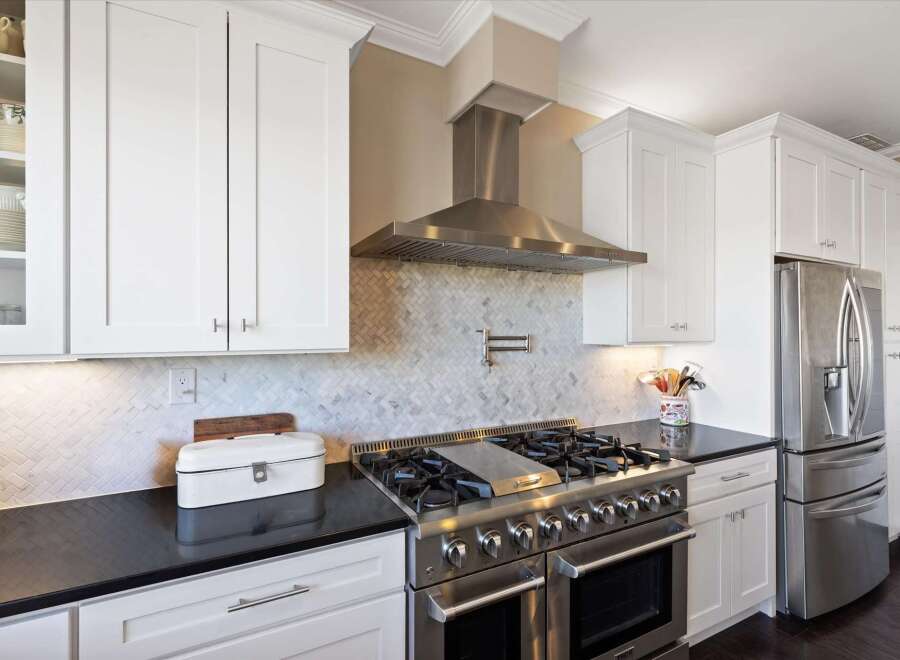 This stunning kitchen boasts modern elegance with its sleek design and high-end appliances.