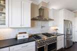 This stunning kitchen boasts modern elegance with its sleek design and high-end appliances.