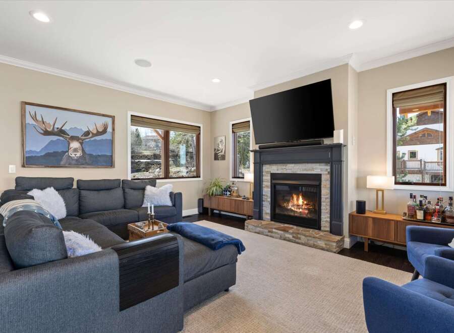 Step into luxury with this stunning living room, featuring a cozy fireplace and a large flat-screen TV, perfect for entertaining.