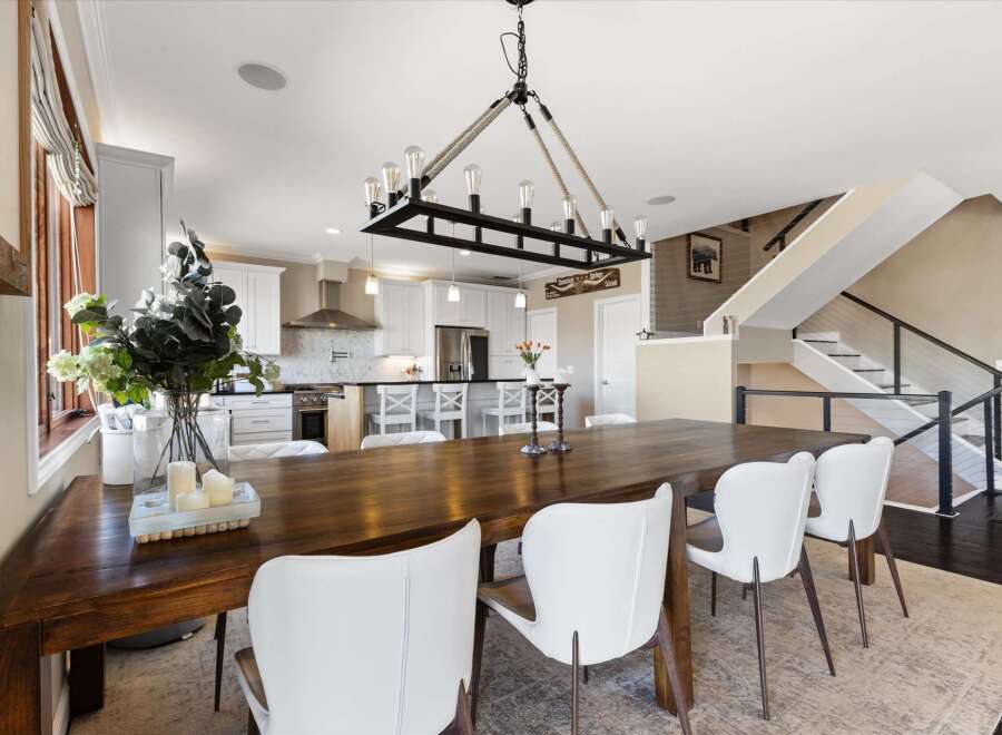 This stunning dining room showcases a beautiful blend of modern and rustic design elements.
