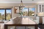 This stunning dining room boasts a rustic wooden table, perfect for hosting gatherings.