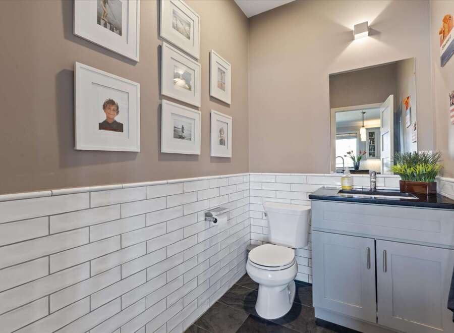 This stunning bathroom features a modern design with white subway tile and a sleek vanity.