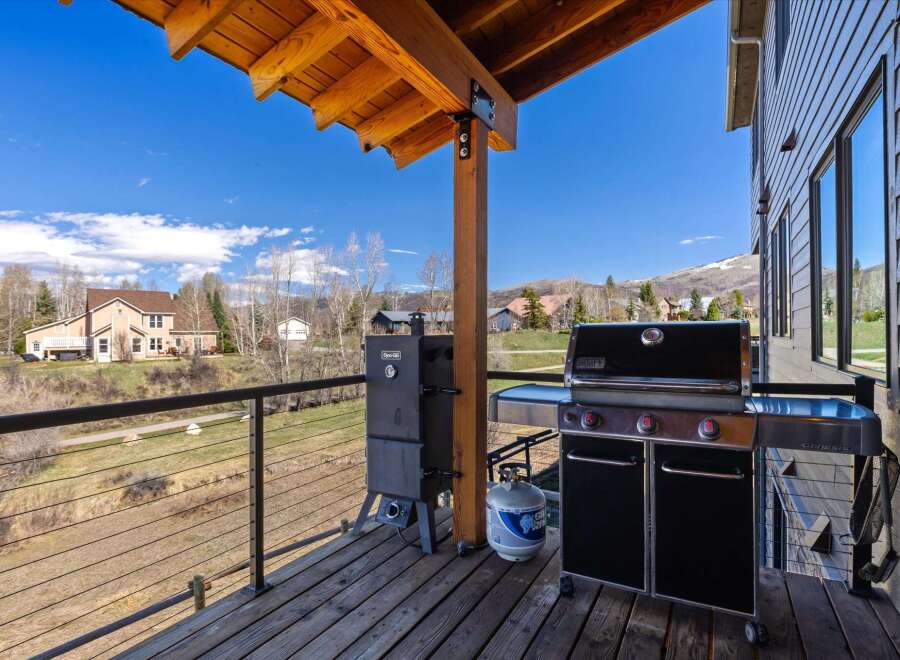Enjoy outdoor living at its finest with this stunning property featuring a spacious deck and a fully equipped grilling area.