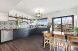 This stunning kitchen boasts a modern design with sleek, dark cabinetry and beautiful patterned backsplash.