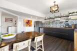 This stunning kitchen boasts a modern design with sleek black cabinetry and a beautiful wooden countertop.
