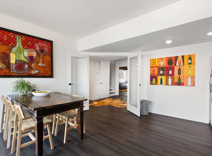 This stunning dining area boasts a dark wood dining table and chairs, perfect for hosting gatherings.